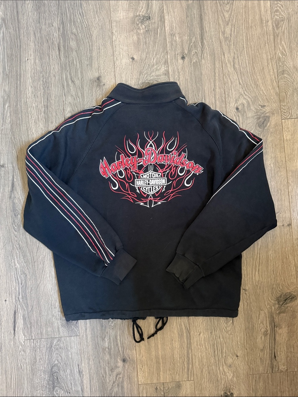 Vintage Harley-Davidson Black Jacket with Red Flame Logo and Stripe Accents